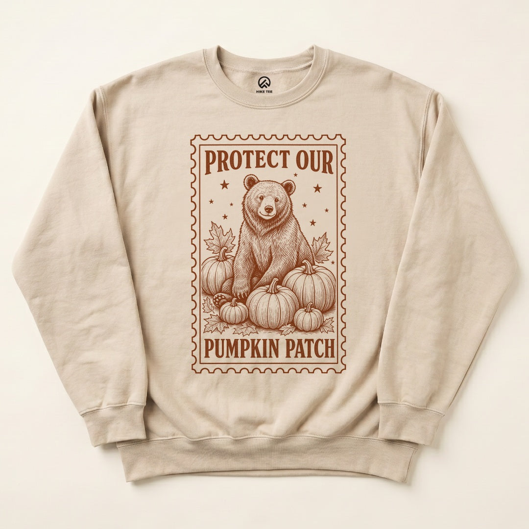 Sand Protect Our Pumpkin Patch Sweatshirt with a vintage-style bear among pumpkins in a stamp frame graphic