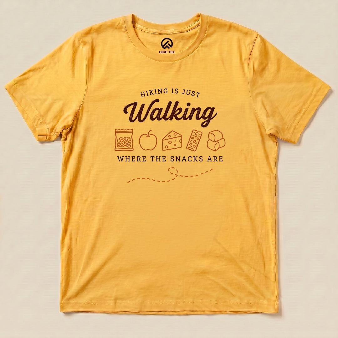 Yellow Gold Hiking Is Just Walking Where the Snacks Are Shirt with a trail snacks graphic