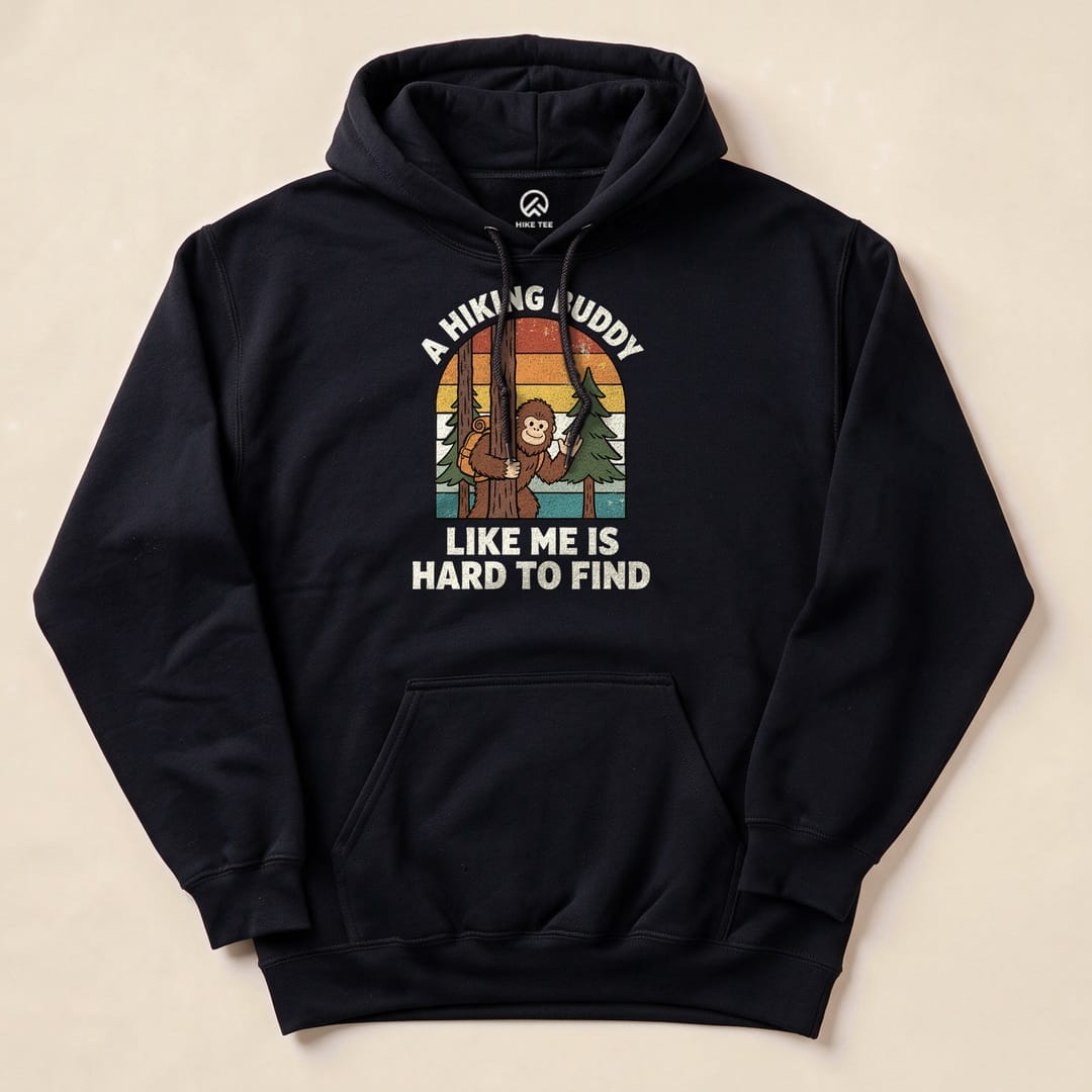 A navy hoodie featuring a graphic with a cheerful monkey holding a hiking stick, stating "A Hiking Buddy Like Me Is Hard To Find.