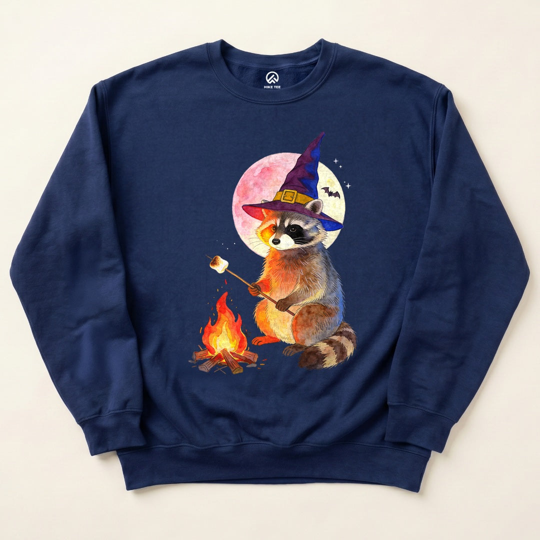 Navy Raccoon Witch Campfire Sweatshirt with a raccoon in a witch hat roasting a marshmallow by the campfire graphic