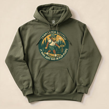 The Sasquatch Sighted Hoodie features a humorous graphic of Sasquatch walking on a trail, with the text "It was just Dad in flip-flops.