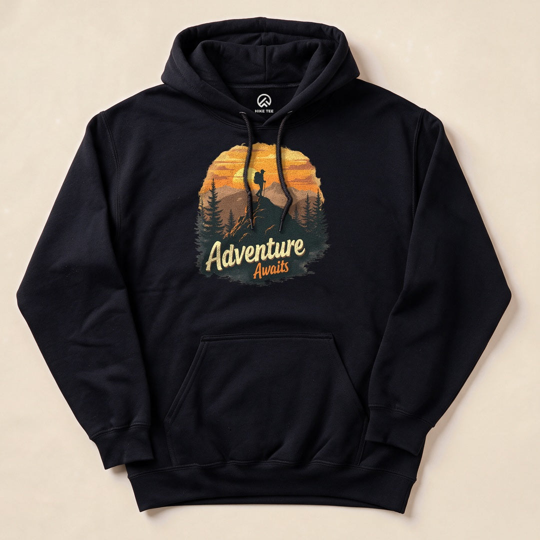 Black Adventure Awaits Hoodie with a sunset hiker illustration
