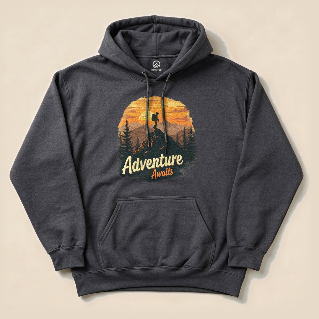 Dark Heather Adventure Awaits Hoodie with a sunset hiker illustration
