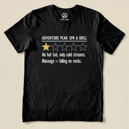Black graphic t-shirt featuring the slogan "Adventure Peak Spa & Grill" with a one-star rating and humorous text about cold streams.