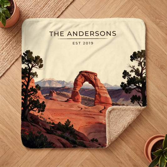 Graphic t-shirt featuring the "Arches Delicate Arch Sunset Sherpa Blanket" design with vibrant colors and scenic mountain backdrop.