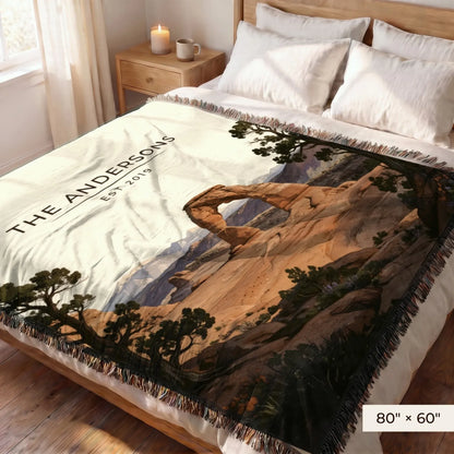 Arches Delicate Arch Sunset Woven Blanket 80x60 on a queen bed
