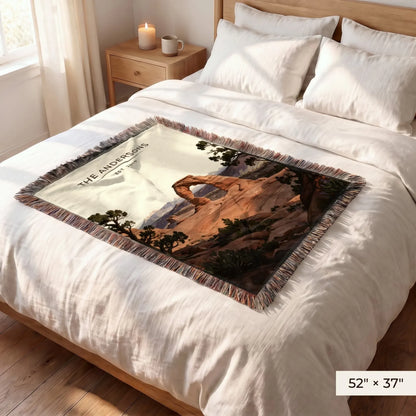 Arches Delicate Arch Sunset Woven Blanket 52x37 on a queen bed