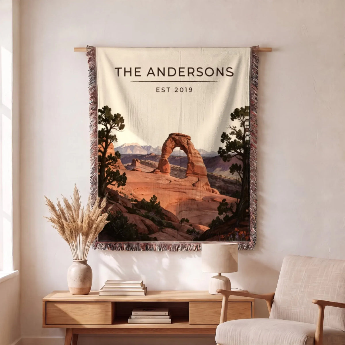 Personalized Arches Delicate Arch Sunset Woven Blanket hanging on a wall, family name woven in