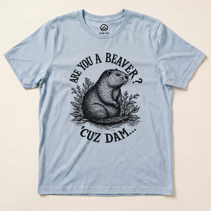 A light blue graphic t-shirt featuring a beaver illustration and the text, "Are You A Beaver? Cuz Dam..." in bold lettering.