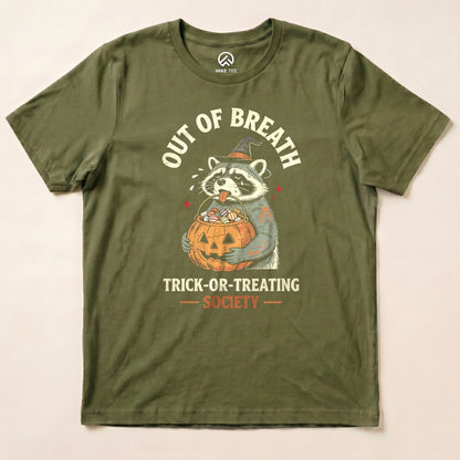 Military Green Out of Breath Trick-or-Treating Society Shirt with a raccoon witch holding a pumpkin full of candy graphic