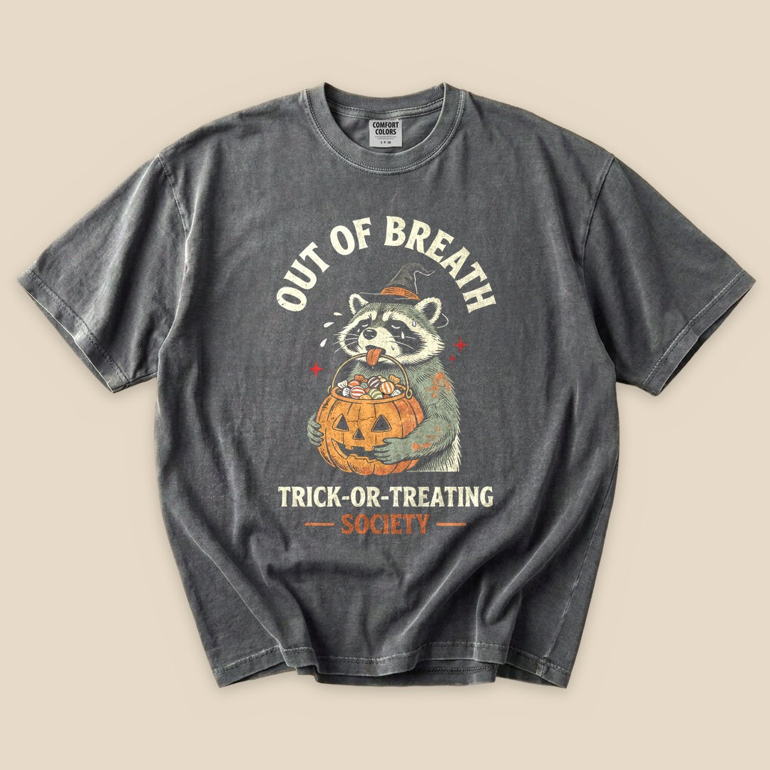 Pepper Out of Breath Trick-or-Treating Society T-Shirt with a raccoon with a jack-o'-lantern trick-or-treating graphic