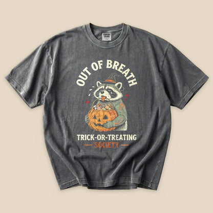 Pepper Out of Breath Trick-or-Treating Society T-Shirt with a raccoon with a jack-o'-lantern trick-or-treating graphic