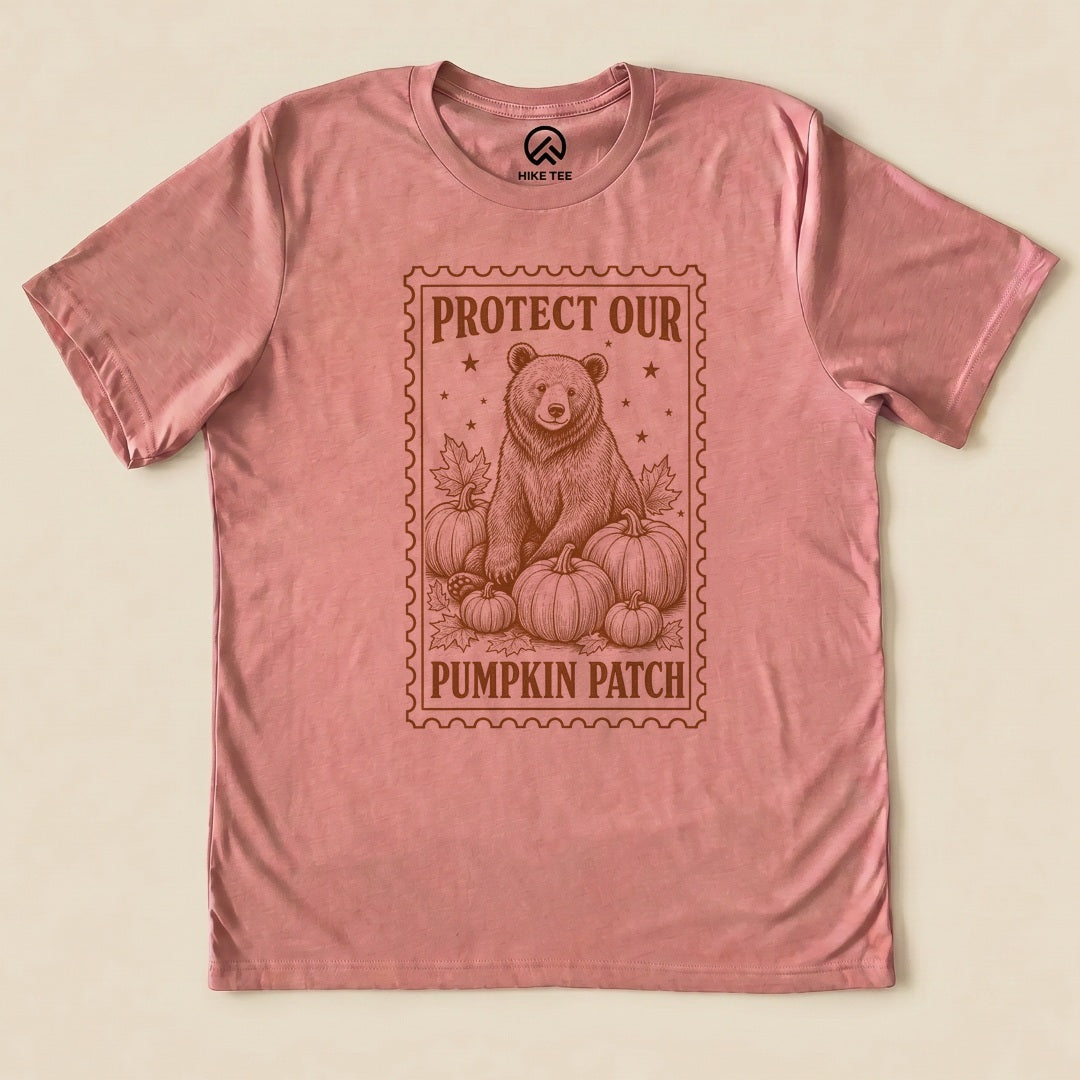 Heather Mauve Protect Our Pumpkin Patch Shirt with a bear among pumpkins in a vintage stamp frame graphic