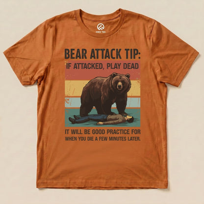 The Bear Attack Tip Retro Shirt features a humorous graphic of a bear with a slogan about playing dead during an attack.