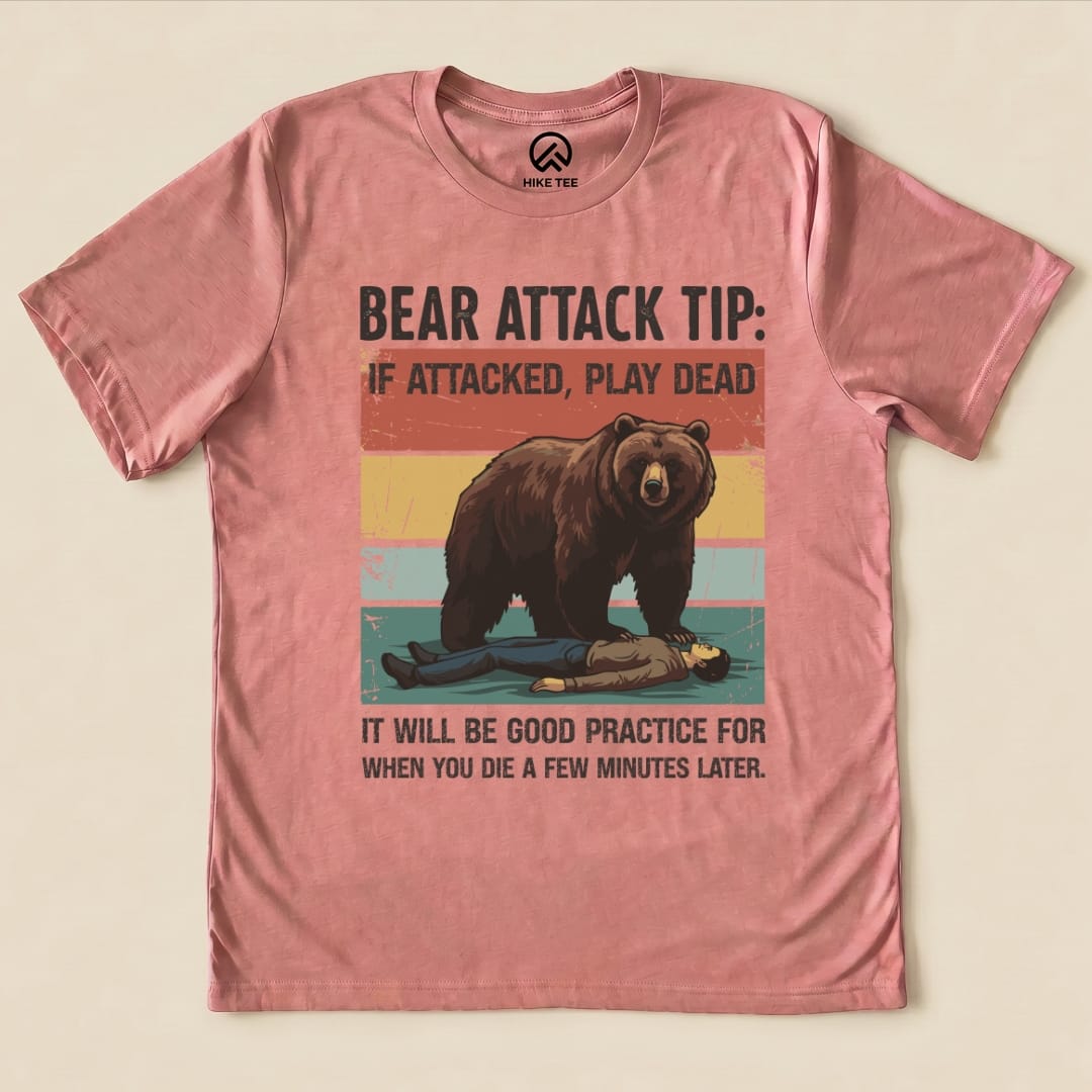 The "Bear Attack Tip Retro Shirt" features a humorous graphic of a bear looming over a person playing dead, with bold text.