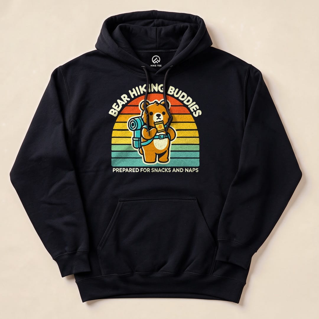 A black Bear Hiking Buddies Hoodie features a graphic of a bear with a backpack against a retro sunset, saying "Prepared for Snacks and Naps.