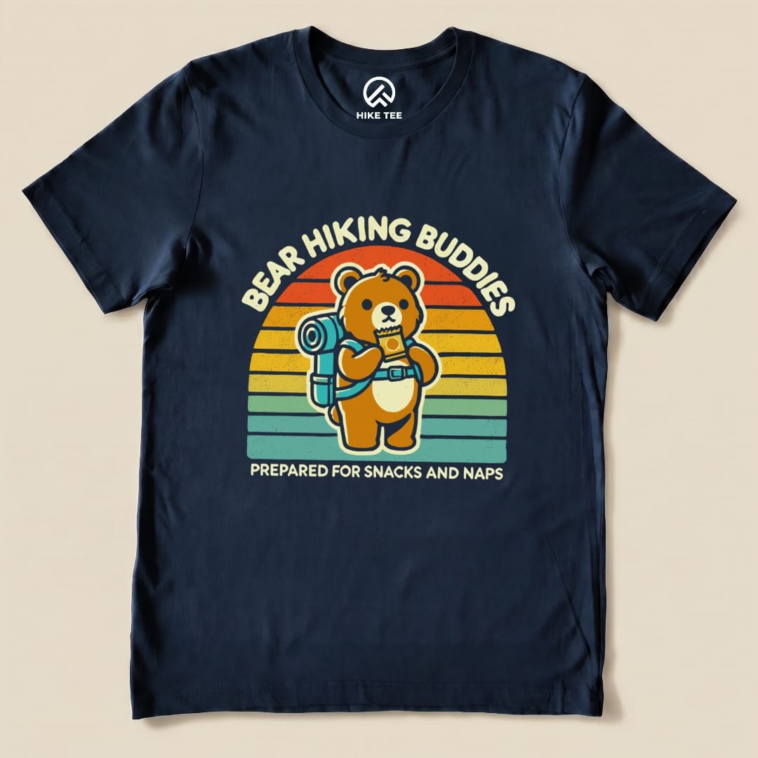 A navy graphic t-shirt featuring a bear with a backpack and the text "Bear Hiking Buddies" and "Prepared for snacks and naps.