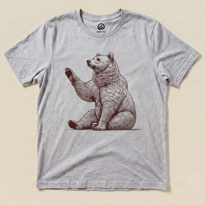 A light gray graphic t-shirt featuring a seated bear with a raised paw, titled "Bear is Watching Shirt.