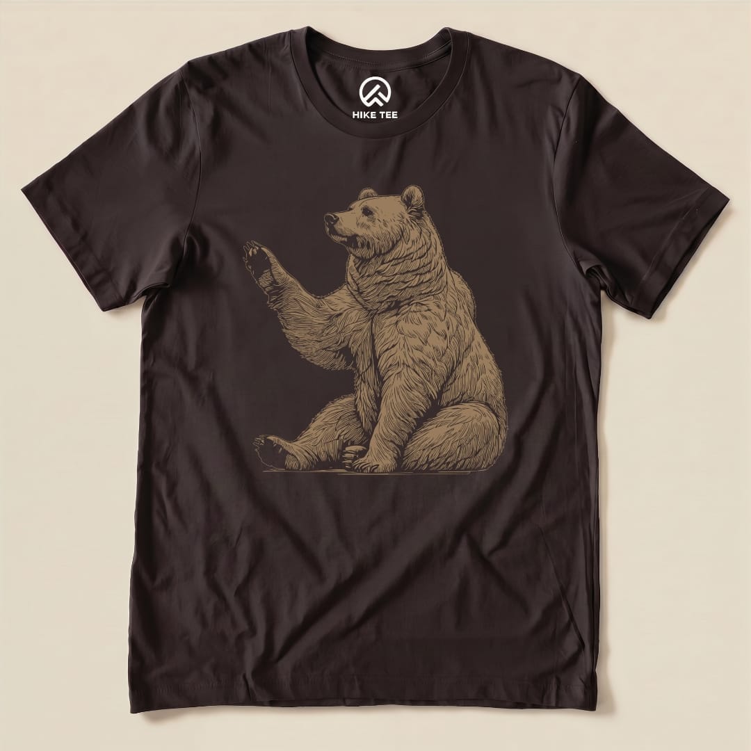 A graphic t-shirt featuring a detailed illustration of a waving bear, labeled as the "Bear Is Watching Shirt.