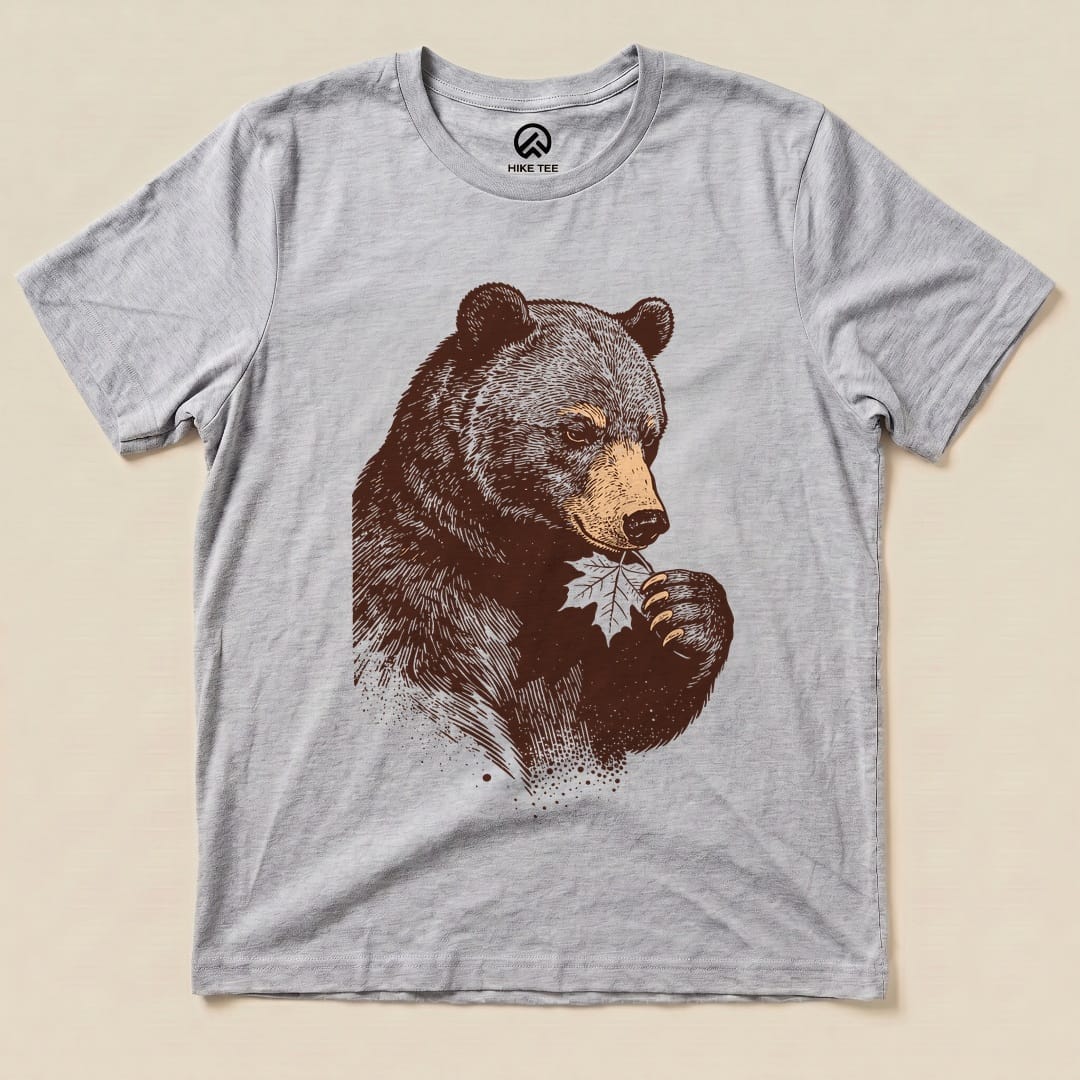 A graphic t-shirt featuring a bear holding a leaf, showcasing the whimsical design of the Bear With Leaf Shirt.