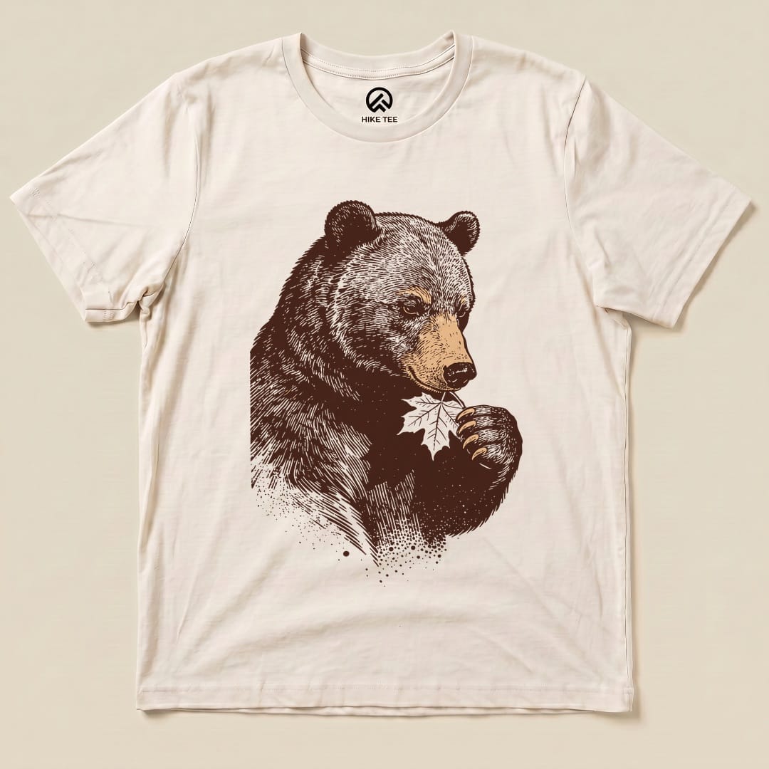 The graphic t-shirt features a bear holding a leaf, showcasing the humorous "Bear With Leaf Shirt" design in earthy tones.