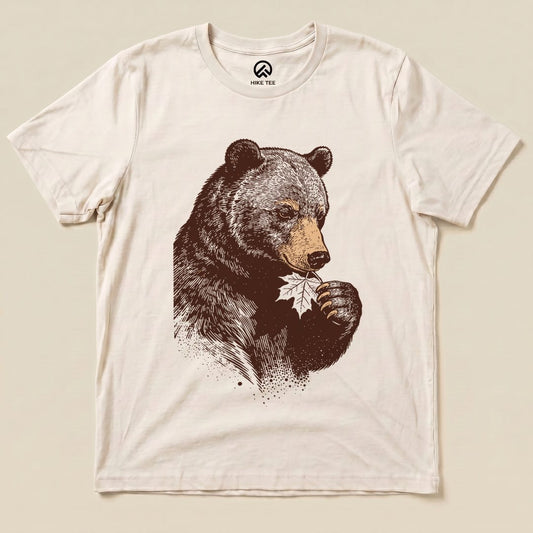 The graphic t-shirt features a bear holding a leaf, showcasing the humorous "Bear With Leaf Shirt" design in earthy tones.