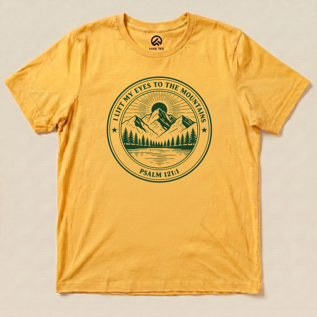 Yellow Gold I Lift My Eyes to the Mountains Shirt with a mountain lake badge with Psalm 121:1 graphic