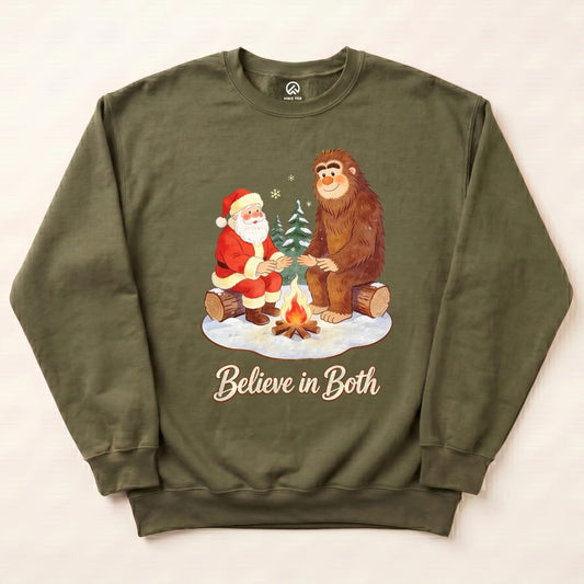 Military Green Believe in Both Sweatshirt with a Santa and Bigfoot warming up by a campfire graphic