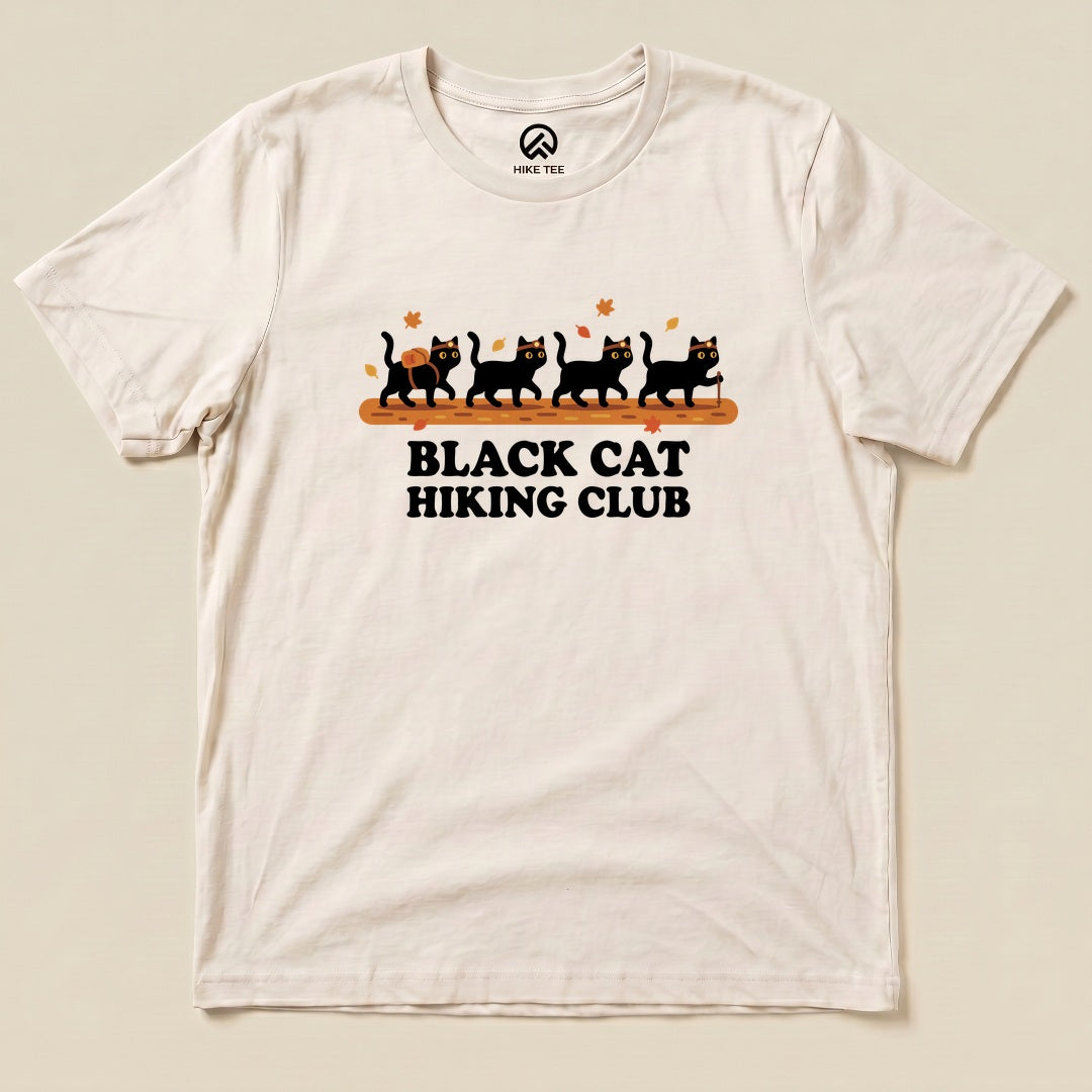 Natural Black Cat Hiking Club Shirt with a row of black cats walking on a log with autumn leaves graphic
