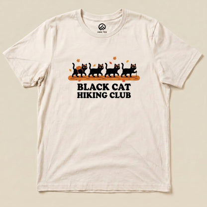 Natural Black Cat Hiking Club Shirt with a row of black cats walking on a log with autumn leaves graphic