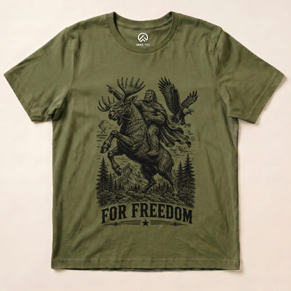 Graphic t-shirt featuring a bold design of Bigfoot riding a moose with the slogan "FOR FREEDOM" below.
