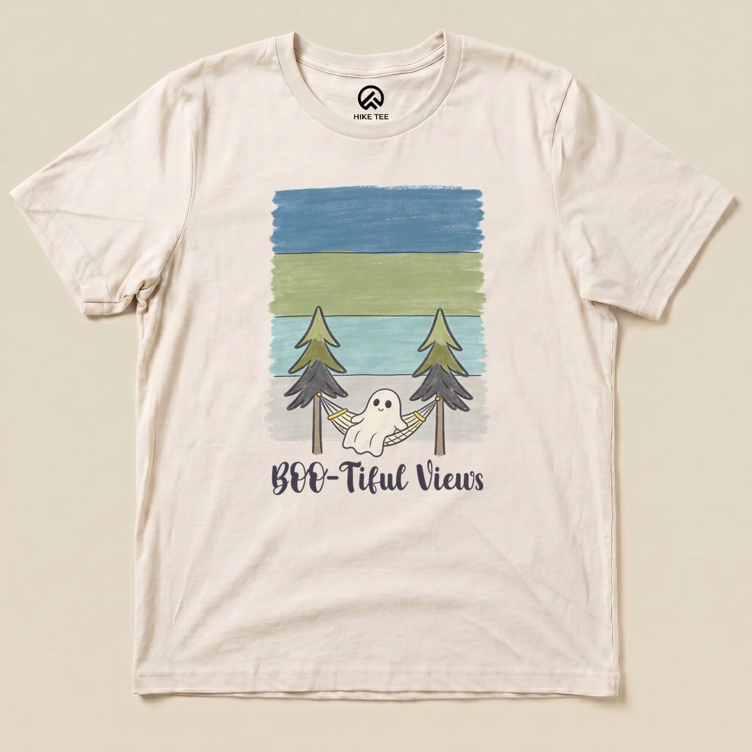 Graphic t-shirt featuring a ghost in a hammock surrounded by trees with the text "Boo-tiful Views" below in a playful font.