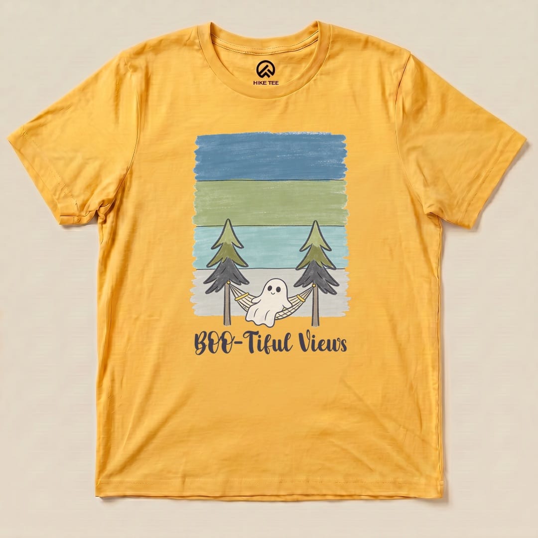 Graphic t-shirt "Boo-tiful Views Shirt" features a ghost in a hammock between trees, set against a layered landscape background.