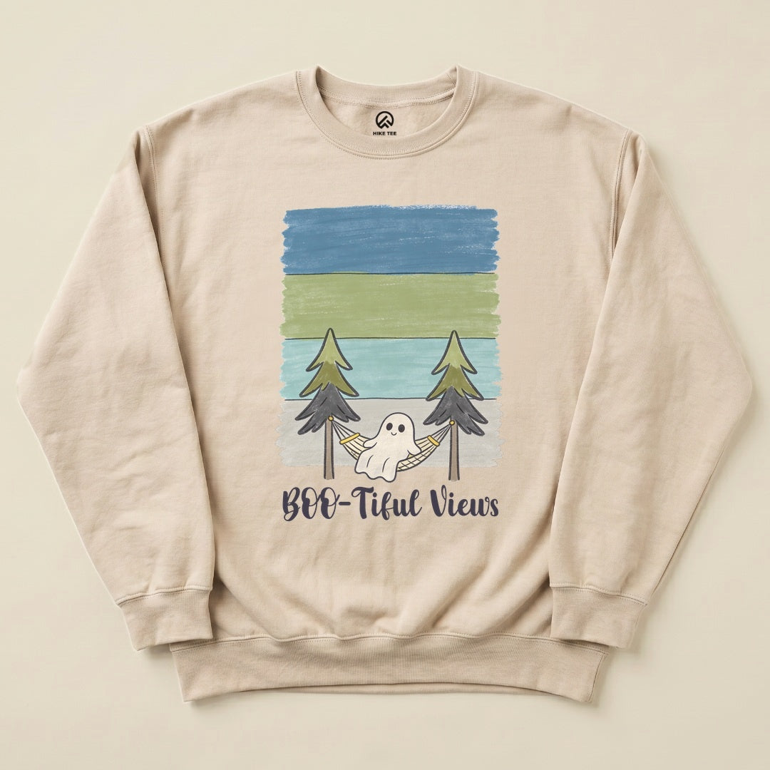 A light beige sweatshirt features the printed phrase "Boo-tiful Views" with a whimsical ghost relaxing in a hammock between trees.