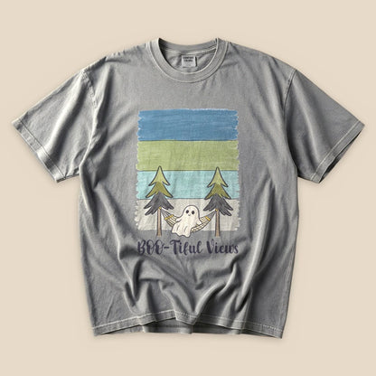 A gray graphic t-shirt featuring a playful design with a ghost in a hammock surrounded by trees and the text "Boo-tiful Views".