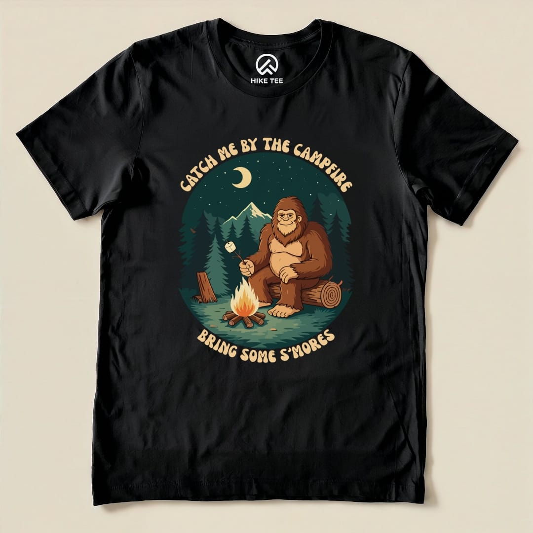 The "Bring Some Smores Shirt" features a playful graphic of a bigfoot by a campfire, roasting marshmallows under a starry sky.