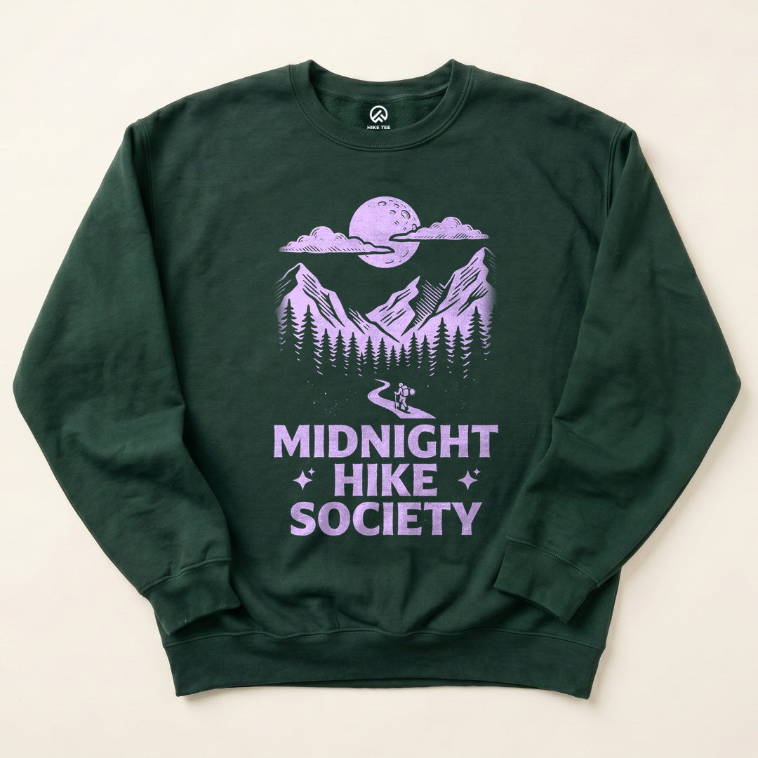 Forest Green Midnight Hike Society Sweatshirt with a full moon over the mountains and a night hiker graphic
