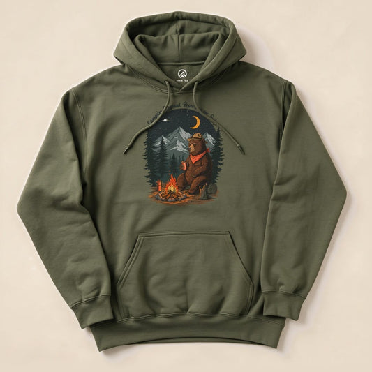 The Campfire Sergeant Bear Hoodie features a graphic of a bear in a hat sitting by a campfire surrounded by trees and mountains.