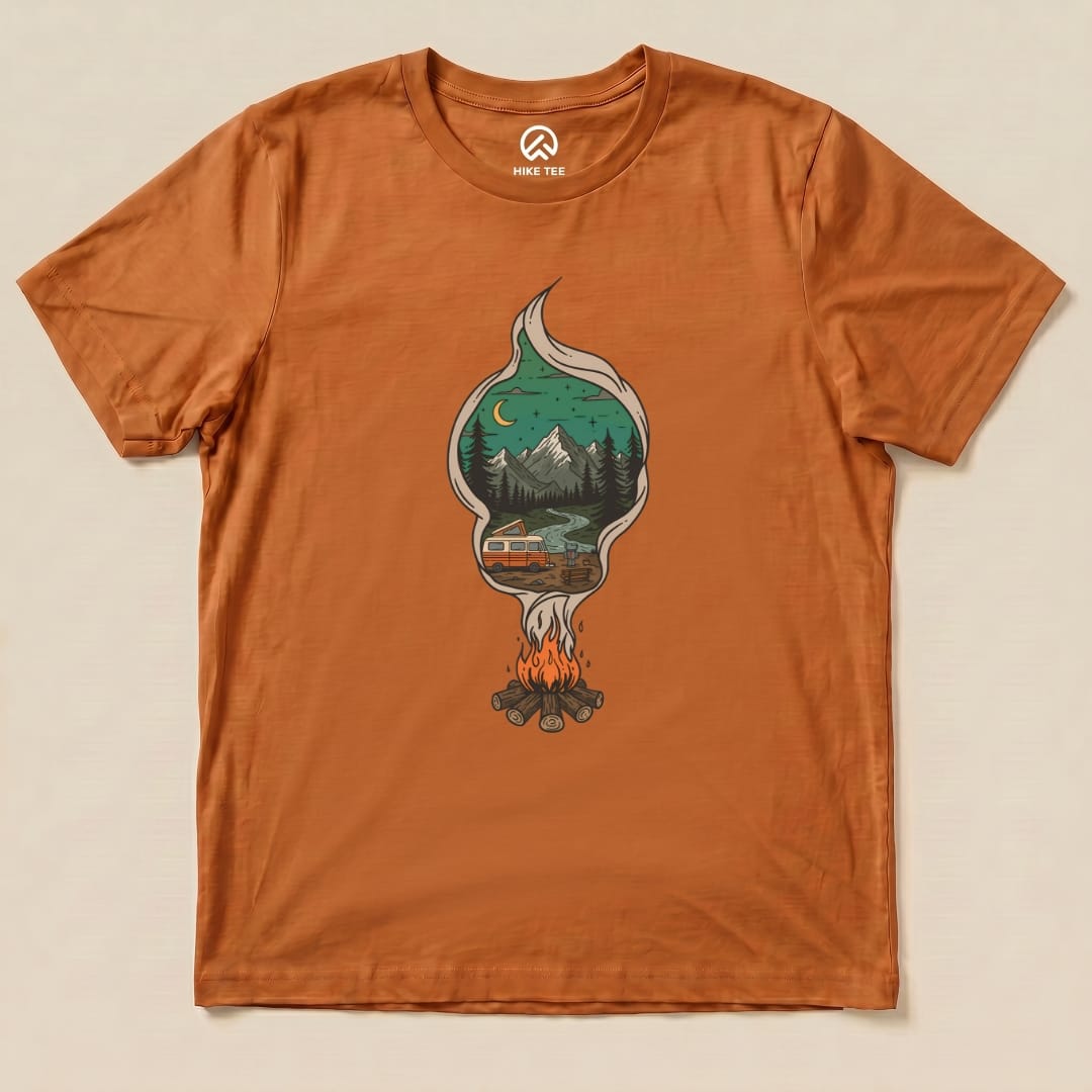 The Campfire Smoke Shirt features a graphic of a campfire with a scenic mountain view and a camper, all on an orange background.