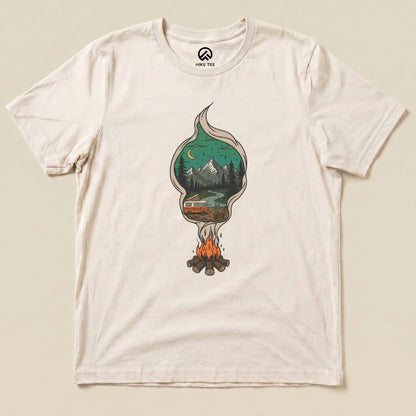 The Campfire Smoke Shirt features a whimsical graphic of a campfire with a tree and mountain scene inside smoke, set on a light-colored tee.