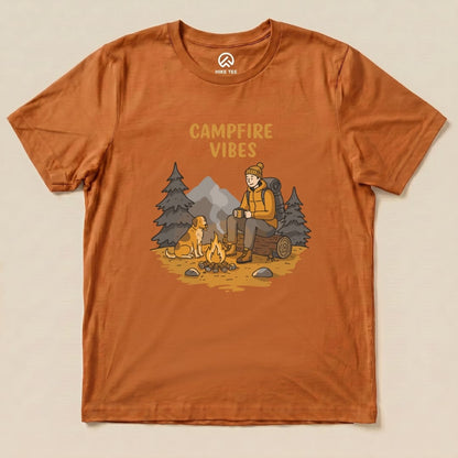 The Campfire Vibes Shirt features a graphic of a hiker sitting by a campfire with a dog, surrounded by trees and mountains.