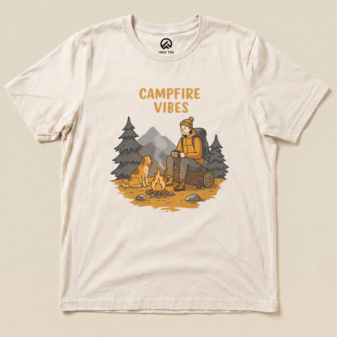 The Campfire Vibes Shirt features a graphic of a hiker sitting by a campfire with a dog, surrounded by trees and mountains.