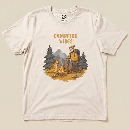 The Campfire Vibes Shirt features a graphic of a hiker sitting by a campfire with a dog, surrounded by trees and mountains.