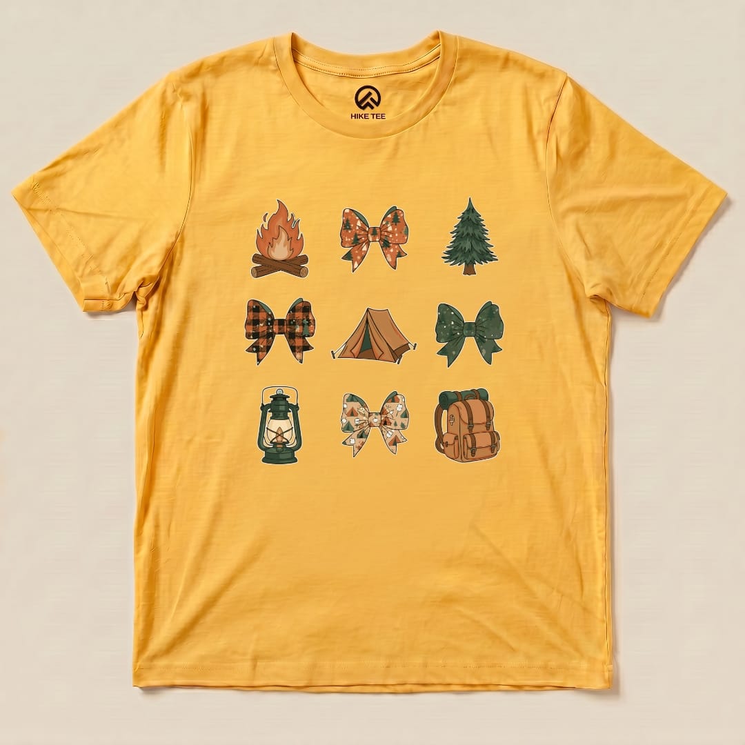 A yellow graphic t-shirt features various camping-themed bows, including a campfire, tent, and lantern, labeled as the "Camping Bows Shirt.