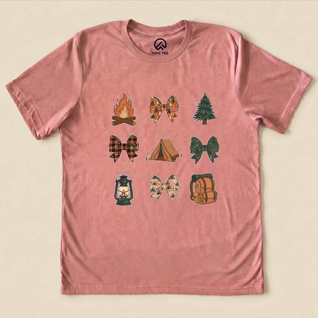 A pink graphic t-shirt features nine outdoor-themed images, including a campfire, tree, lantern, and various bows, titled "Camping Bows Shirt.