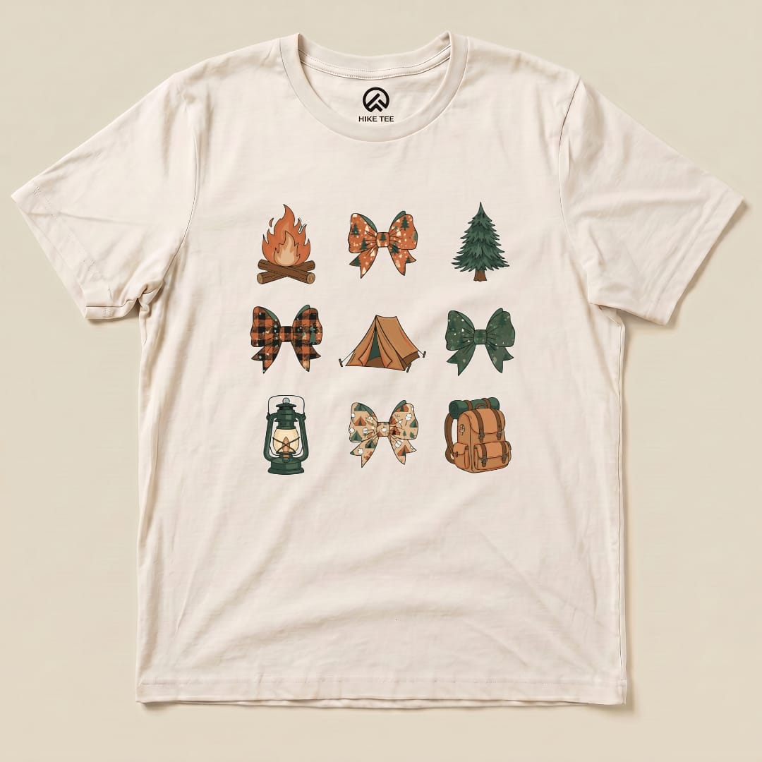 A graphic t-shirt featuring a collection of camping-themed bows, including a fire, tent, and lantern, titled "Camping Bows Shirt.