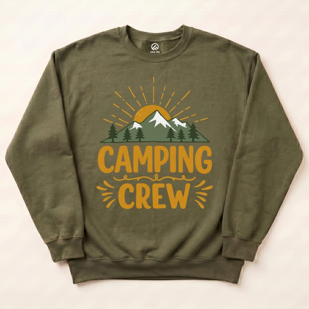 Olive green "Camping Crew Sweatshirt" featuring a graphic design of mountains, trees, and a sun in warm colors.
