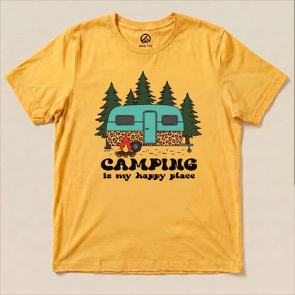 A yellow graphic t-shirt featuring a colorful print of a camper, trees, and the slogan "Camping is my happy place.