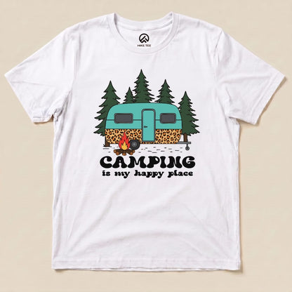 A graphic t-shirt featuring a teal and leopard-print camper surrounded by trees with the slogan "Camping is my happy place.