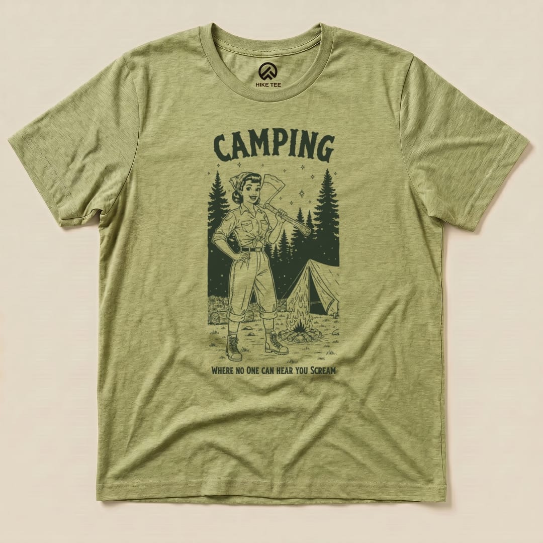 A graphic t-shirt featuring an outdoor scene with the text "Camping Where No One Can Hear You Scream" and a woman wielding an axe.